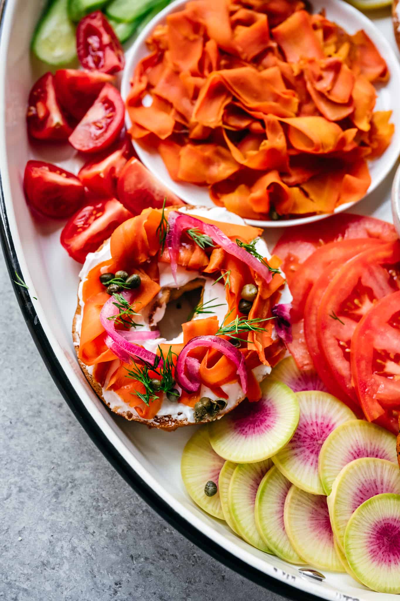 close up overhead of a bagel topped with vegan carrot lox