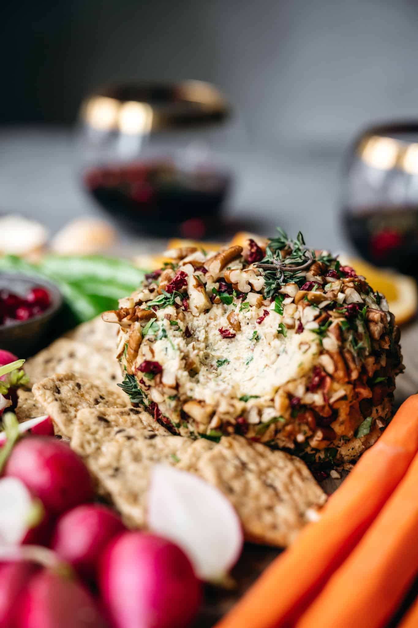 close up side view of vegan cheese ball on platter