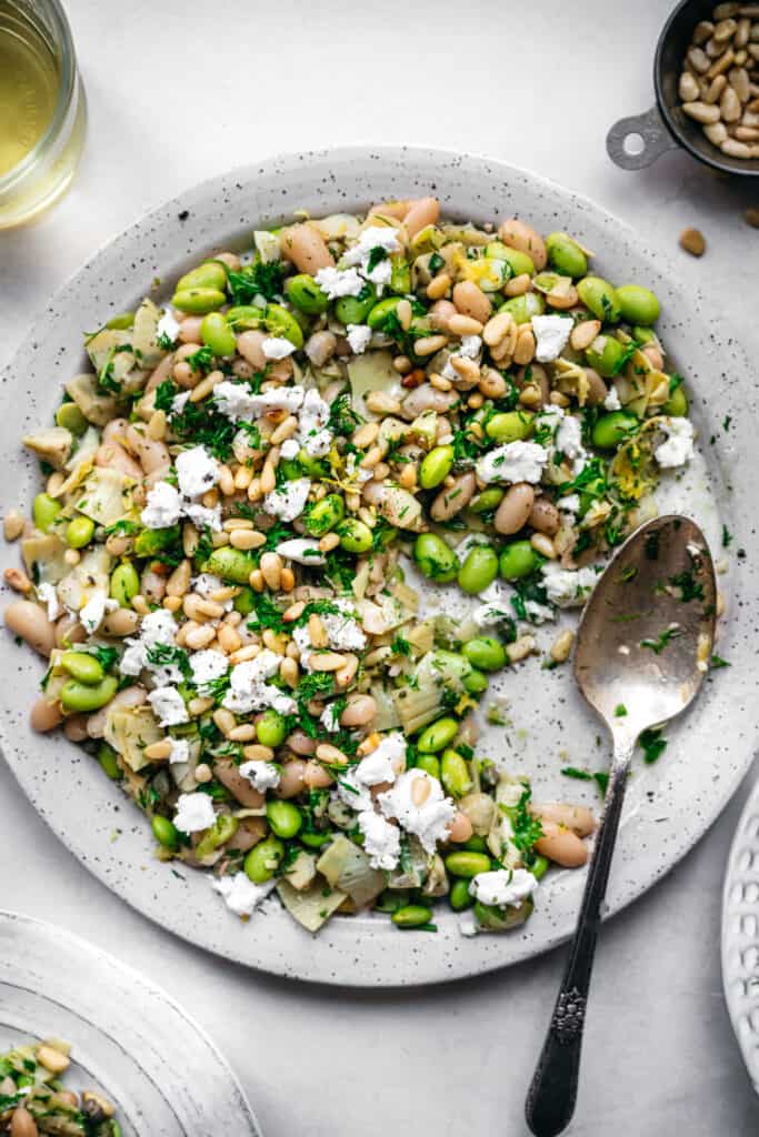 close up view of white bean salad on a white plate