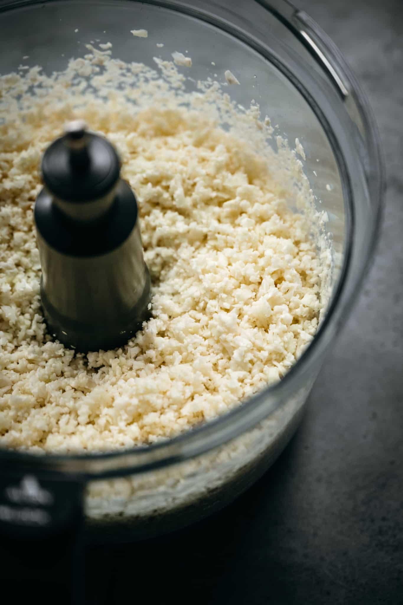 close up view of cauliflower rice in a food processor