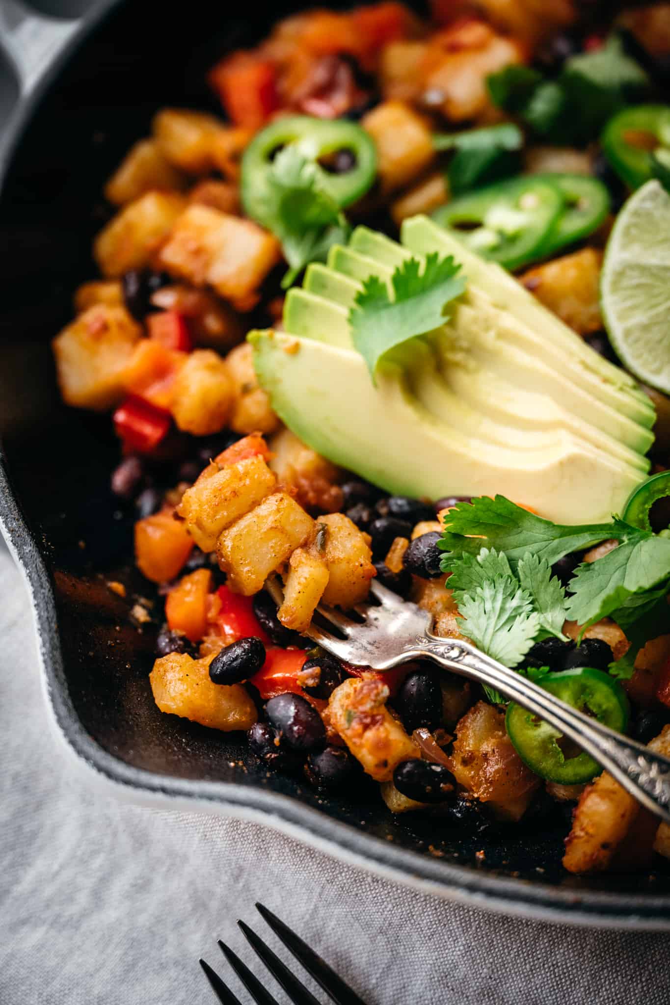 close up view of southwest spiced breakfast potatoes on a fork