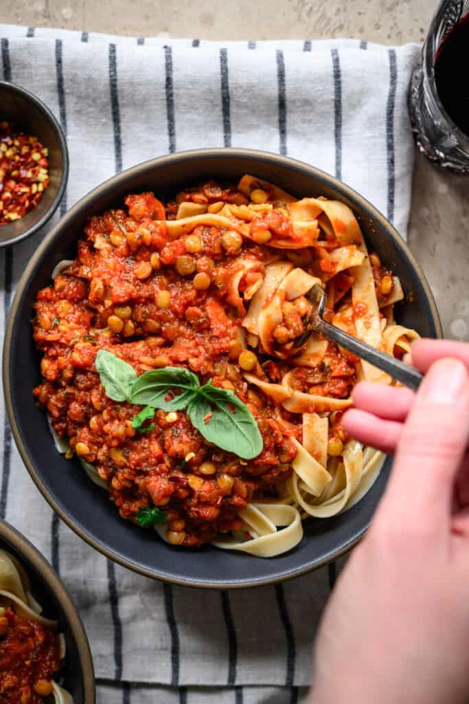 overhead view of pasta with vegan bolognese in a bowl with fork