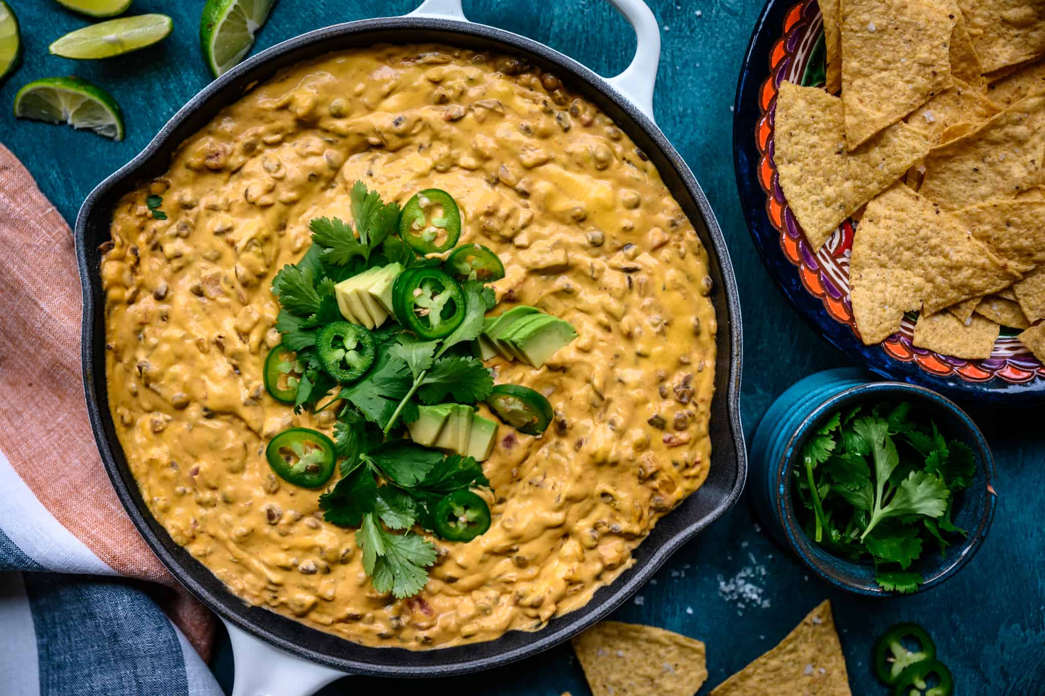 overhead view of vegan chile con queso dip in skillet with tortilla chips