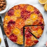 close up overhead of citrus upside down olive oil cake on white background