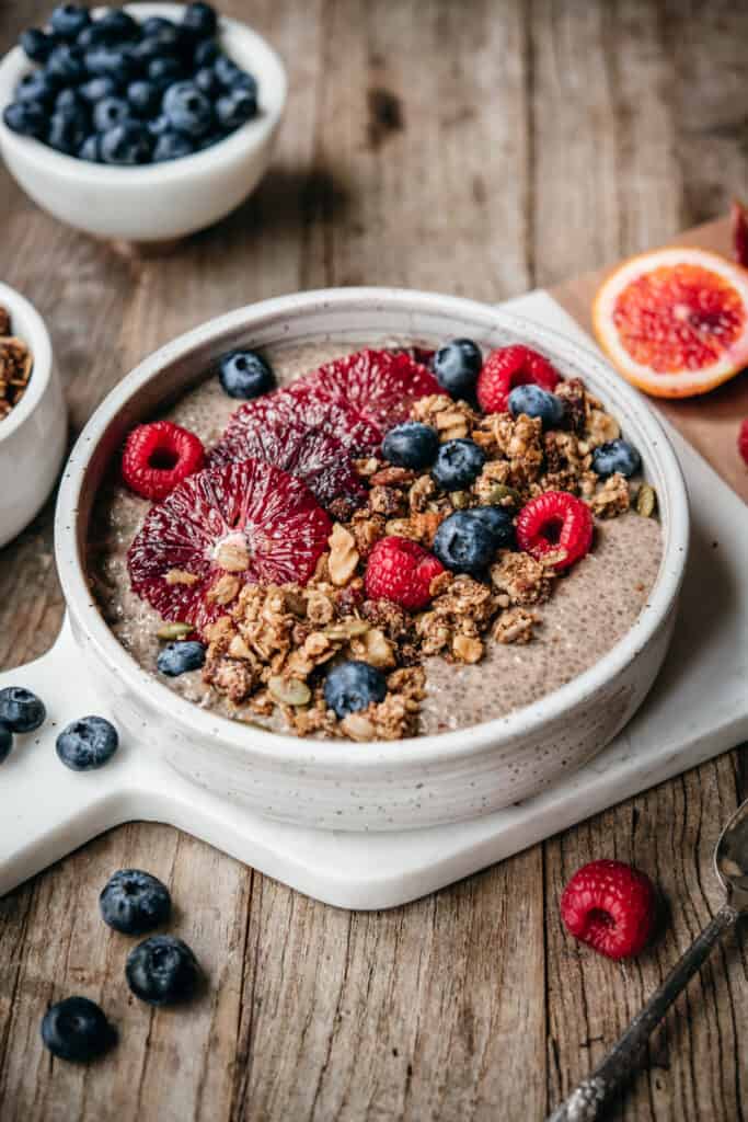 side view of chai spiced chia pudding in bowl with teff granola