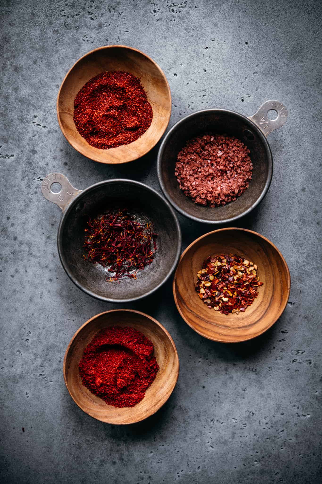 overhead view of spices in small bowls to use in vegan paella recipe