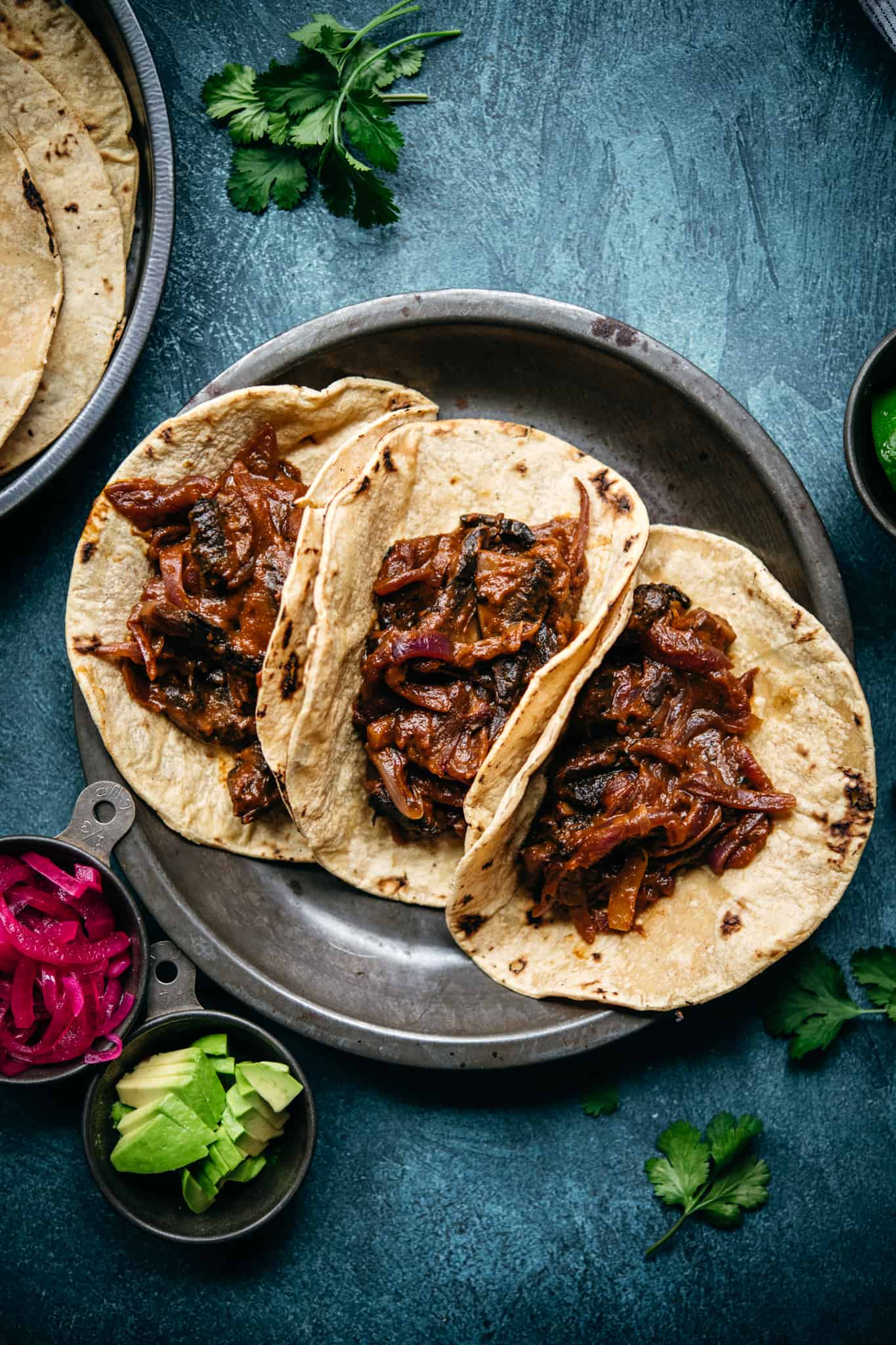 overhead view of vegan mushroom al pastor in charred tortillas