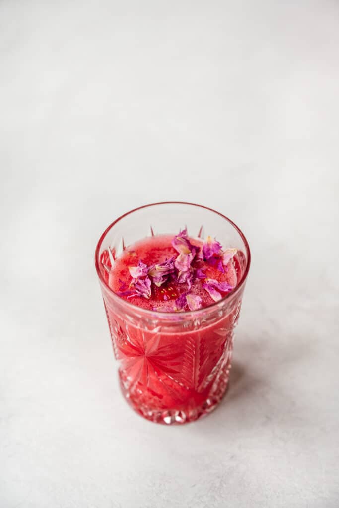 side view of nonalcoholic valentine's day mocktail in antique cocktail glass