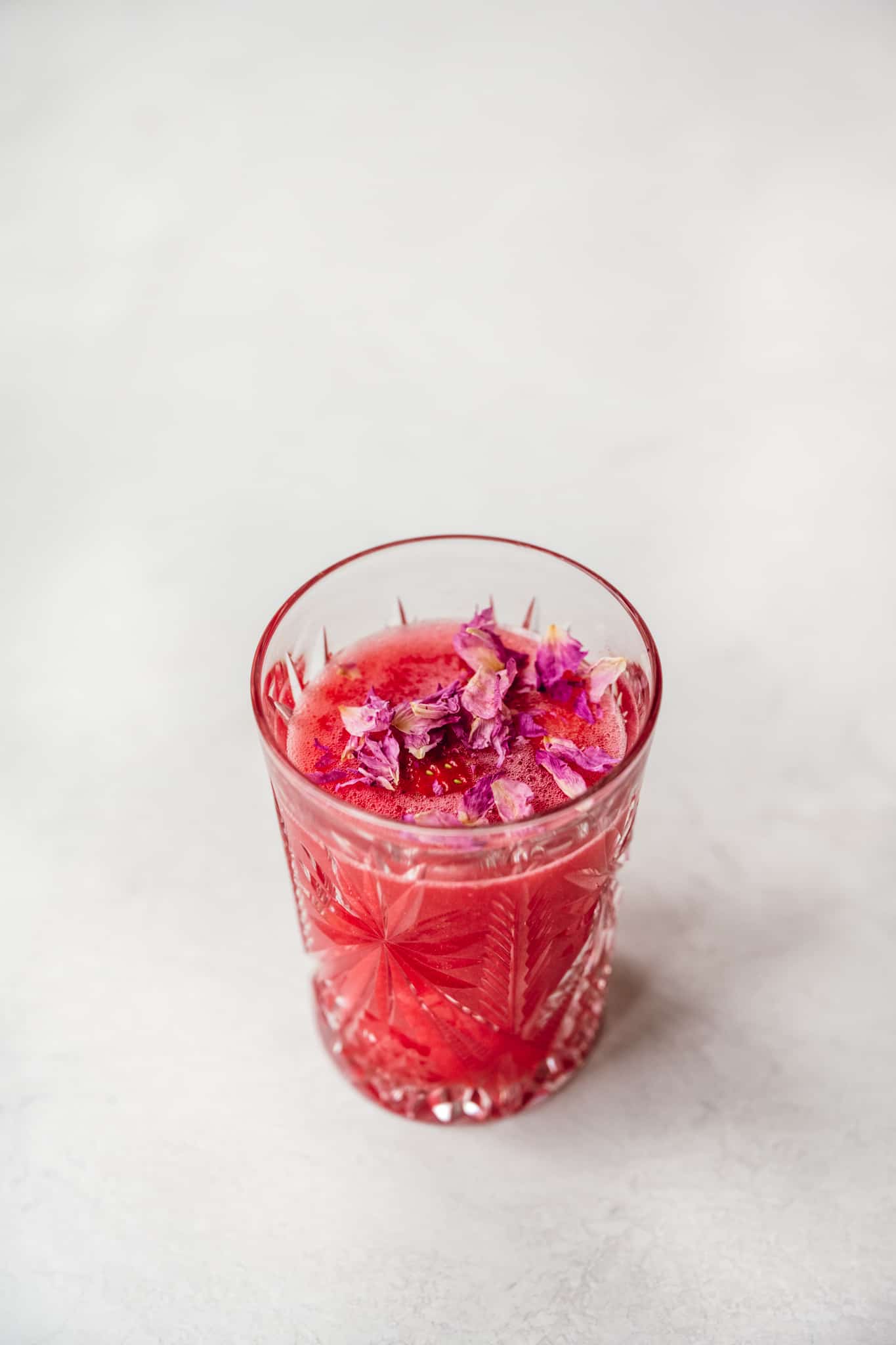side view of nonalcoholic valentine's day mocktail in antique cocktail glass 