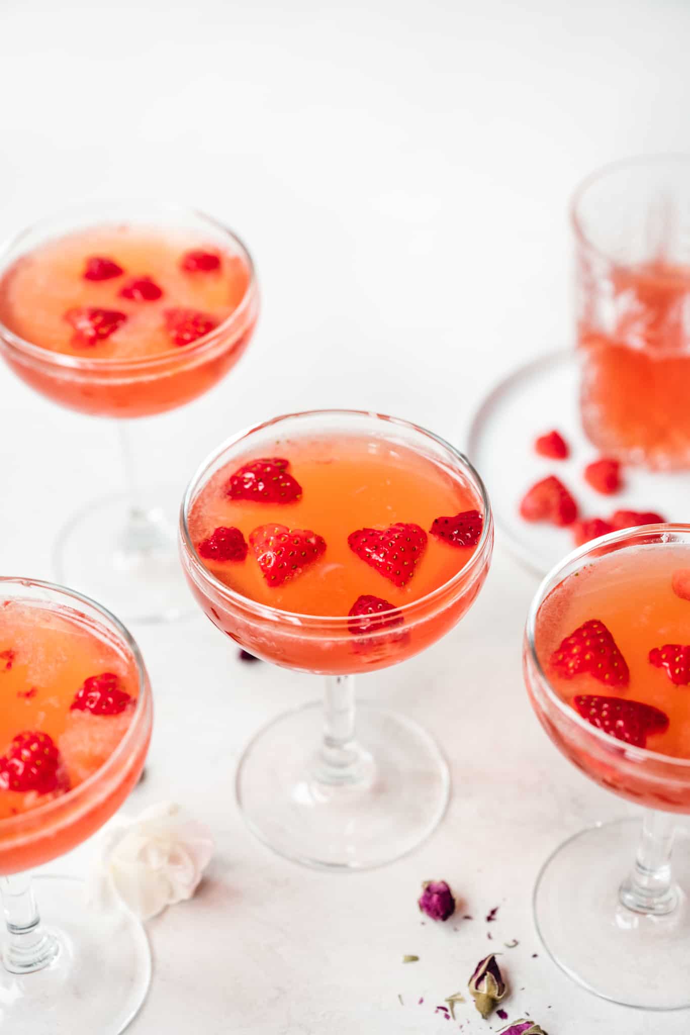 side view of valentine's day cocktails garnished with strawberry hearts