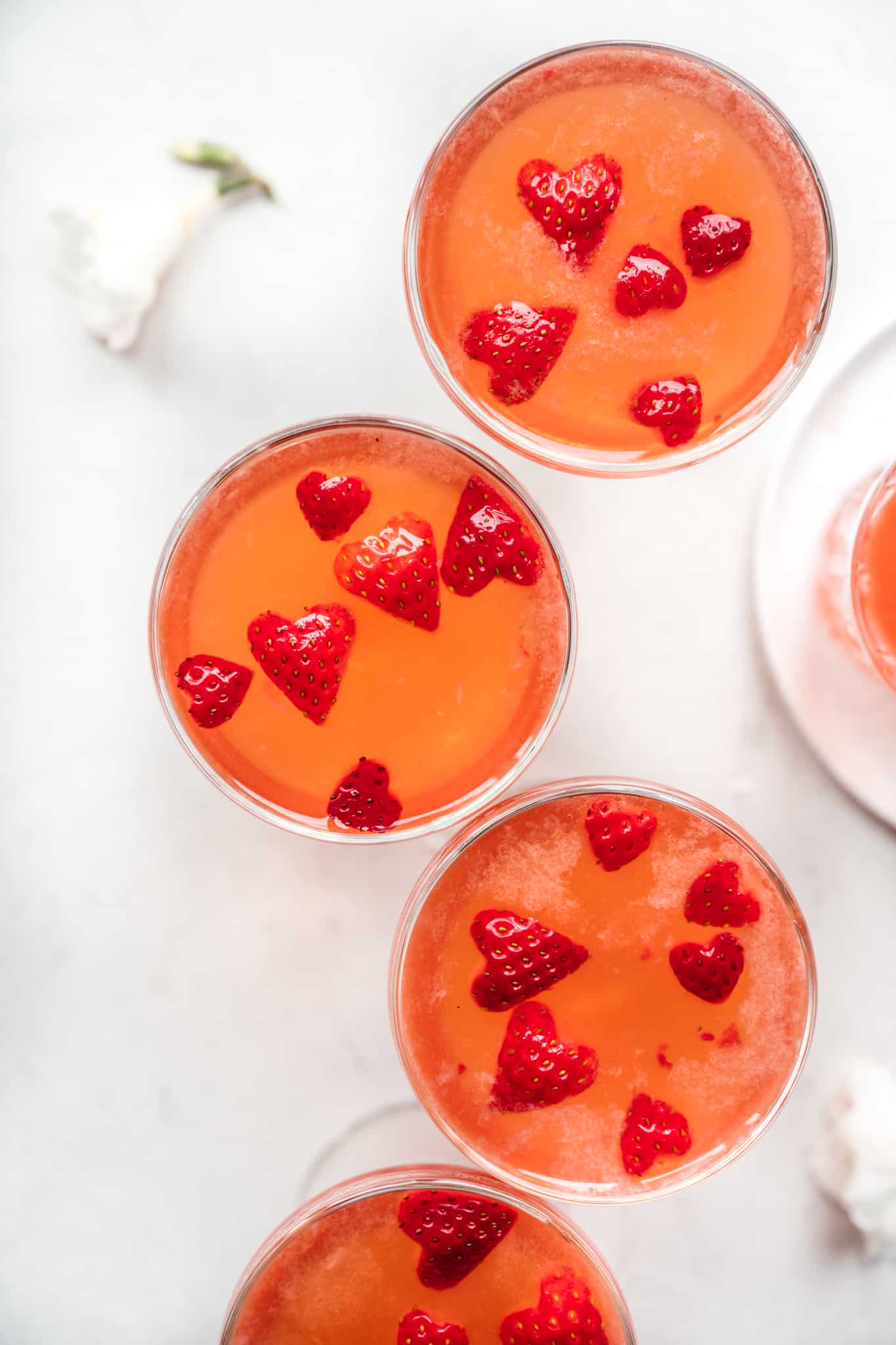 overhead view of four glasses of strawberry vodka cocktails