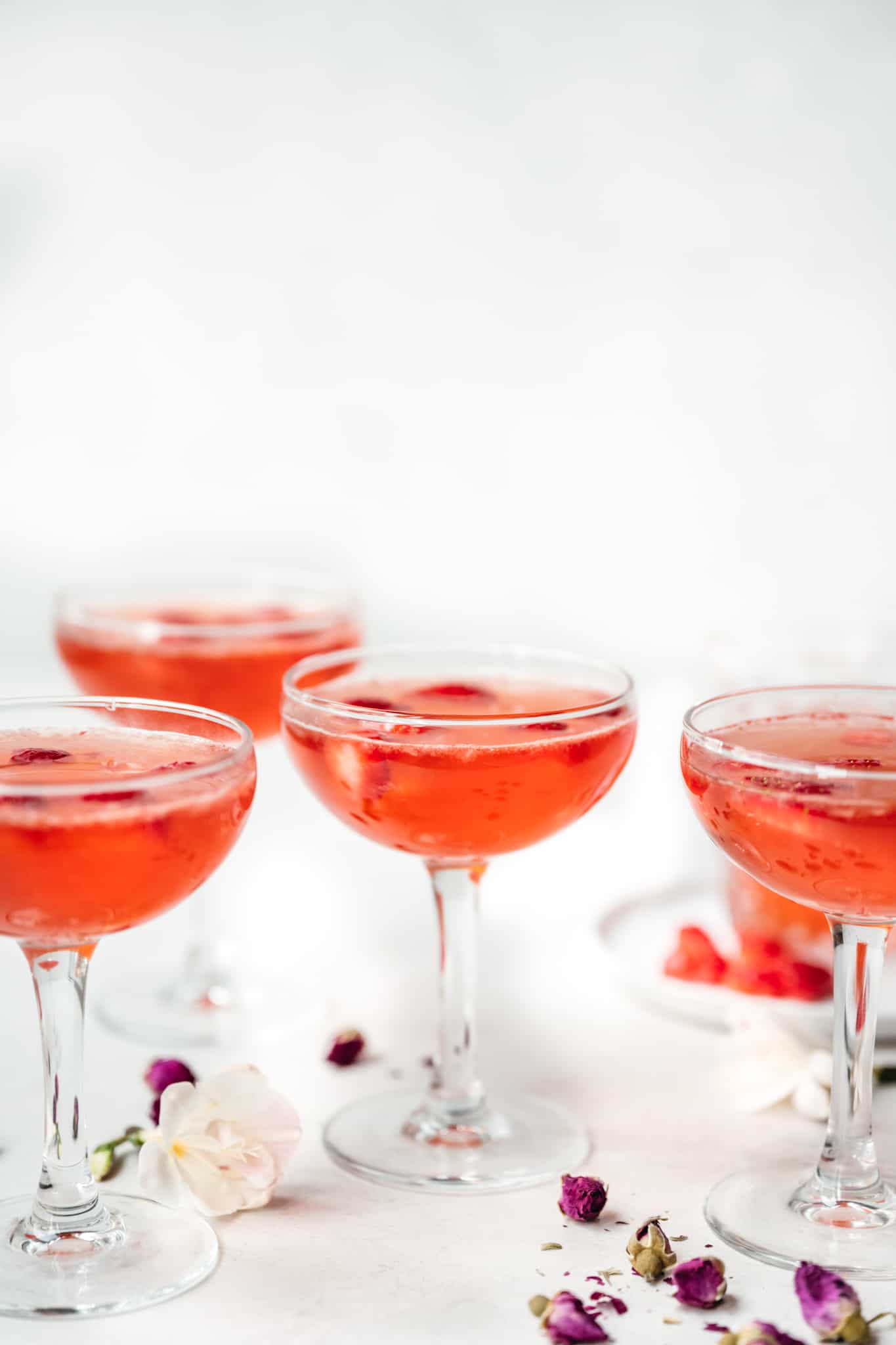 side view of strawberry vodka Valentine's Day cocktail in coupe glasses