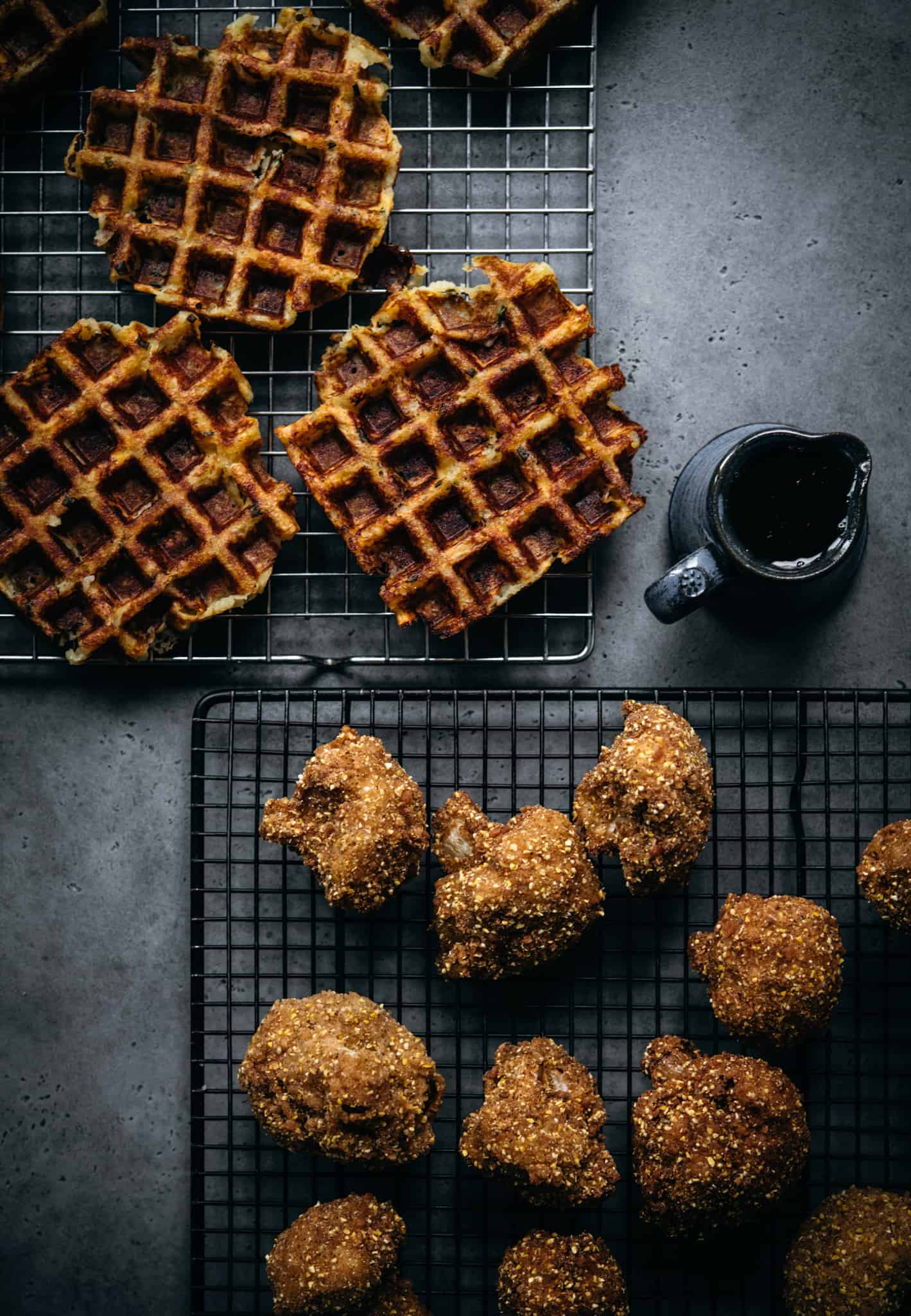 overhead view of mashed potato waffles, vegan fried cauliflower and hot maple syrup