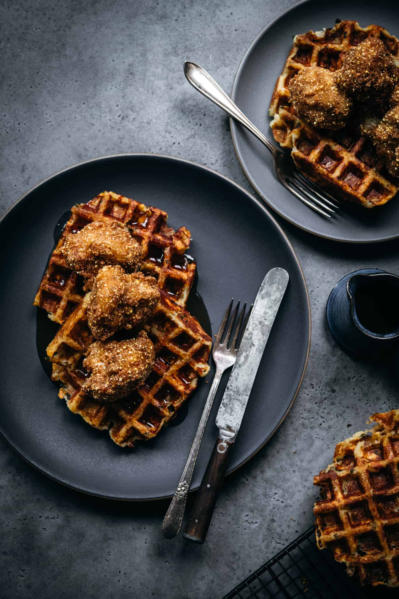 overhead view of plate with vegan chicken and waffles with fork and knife