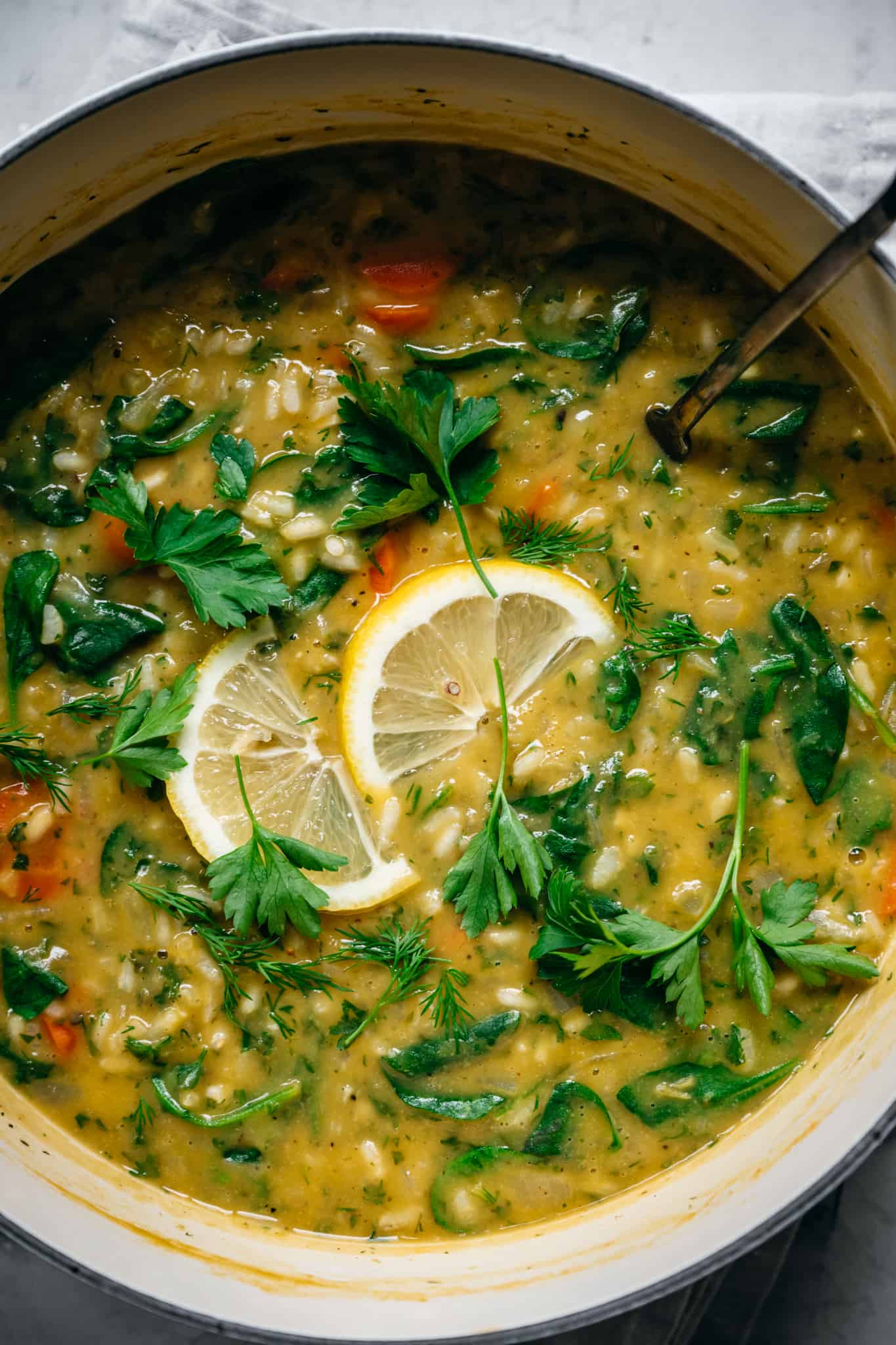 close up view of vegan lemon rice soup in large pot