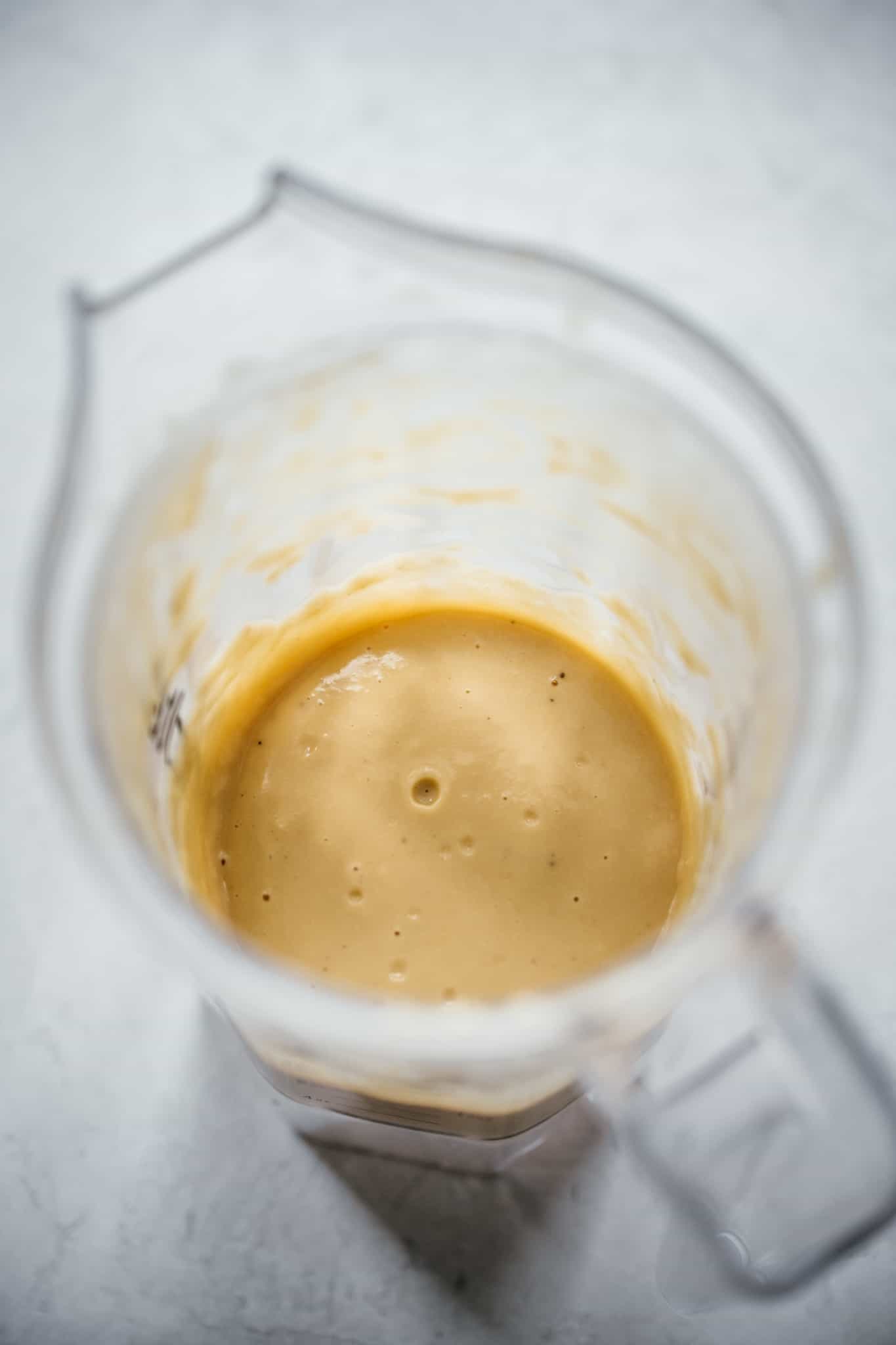 side view of puréed white beans in blender