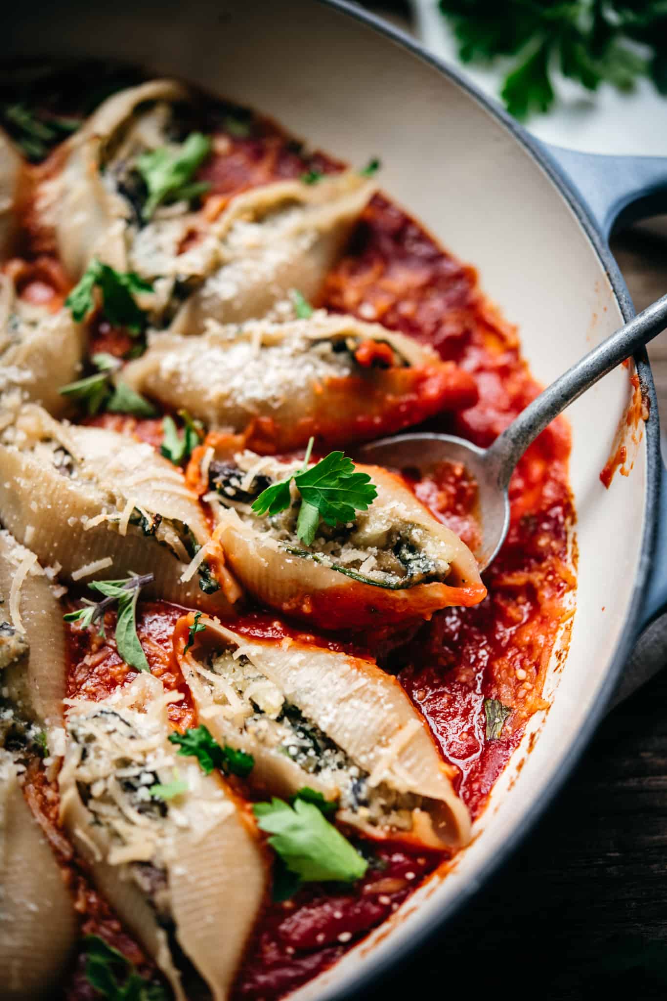 close up side view of vegan stuffed shells in marinara sauce