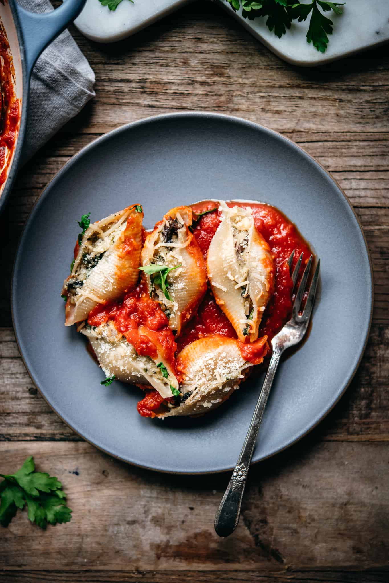 overhead view of vegan stuffed shells on a grey plate