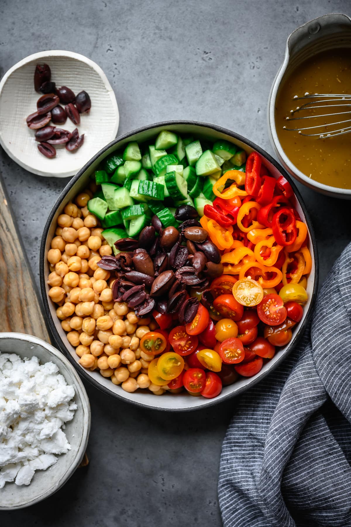 overhead view of greek chickpea salad ingredients in mixing bowl