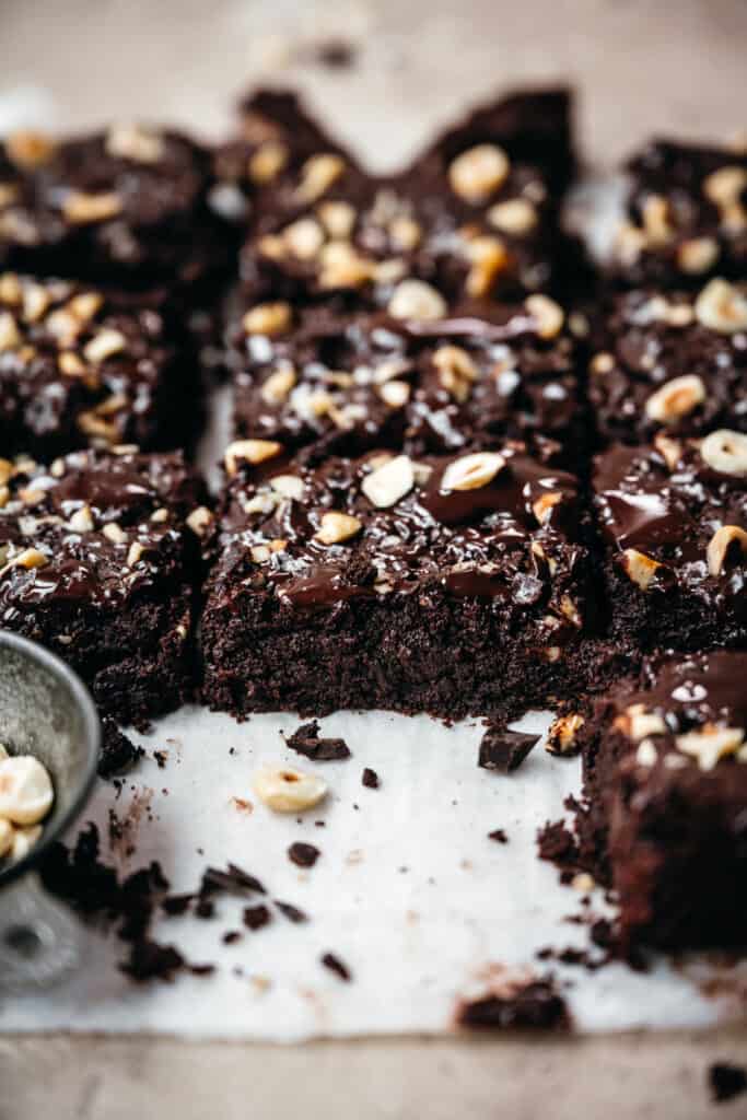 side view of vegan gluten free brownies on parchment paper