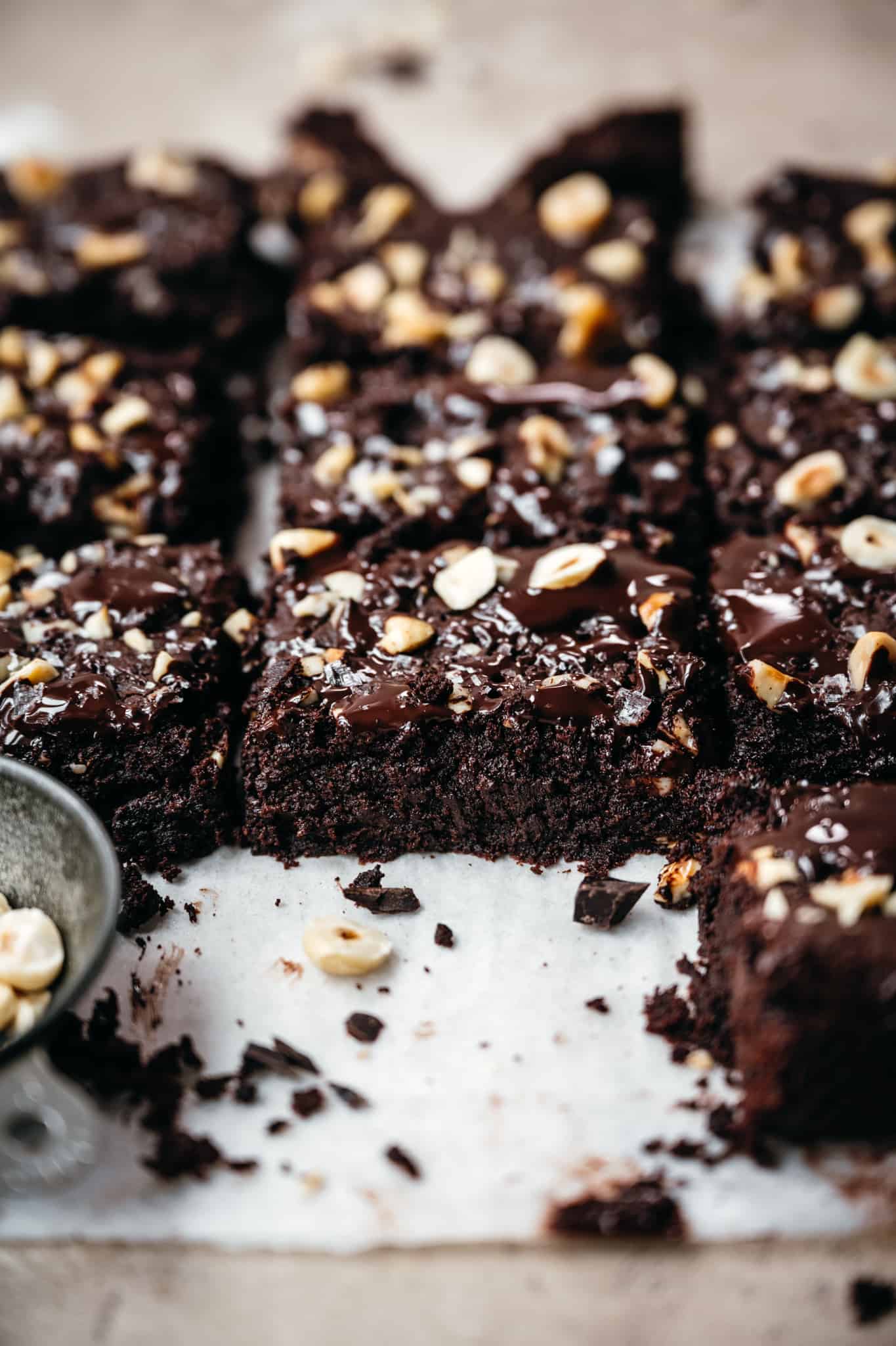 side view of vegan gluten free brownies on parchment paper