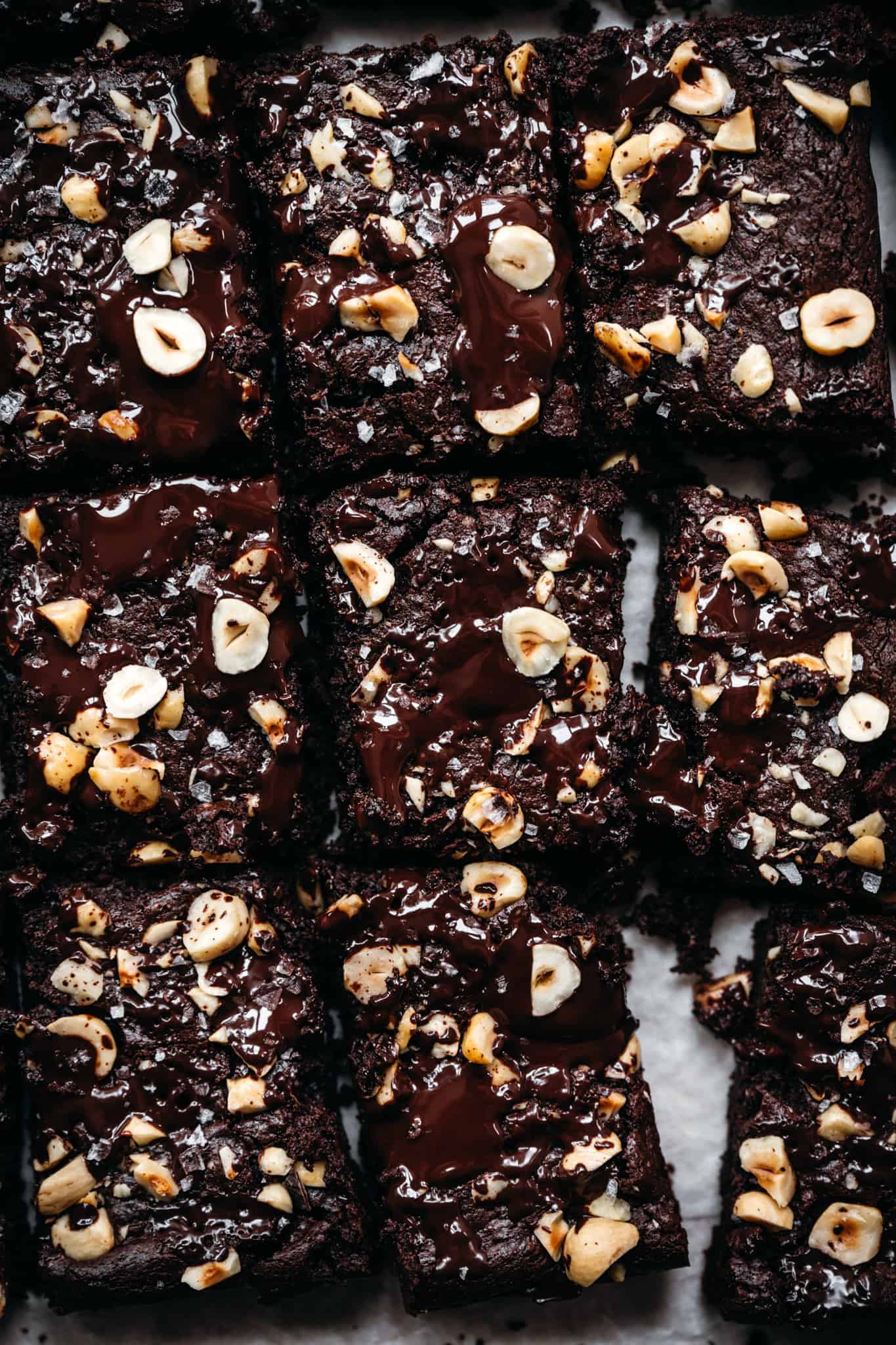 overhead view of hazelnut tahini brownies on parchment paper