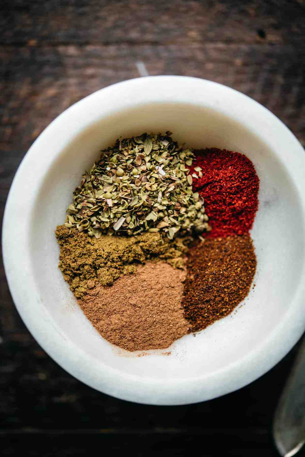 overhead view of spices for vegan chili in a small bowl