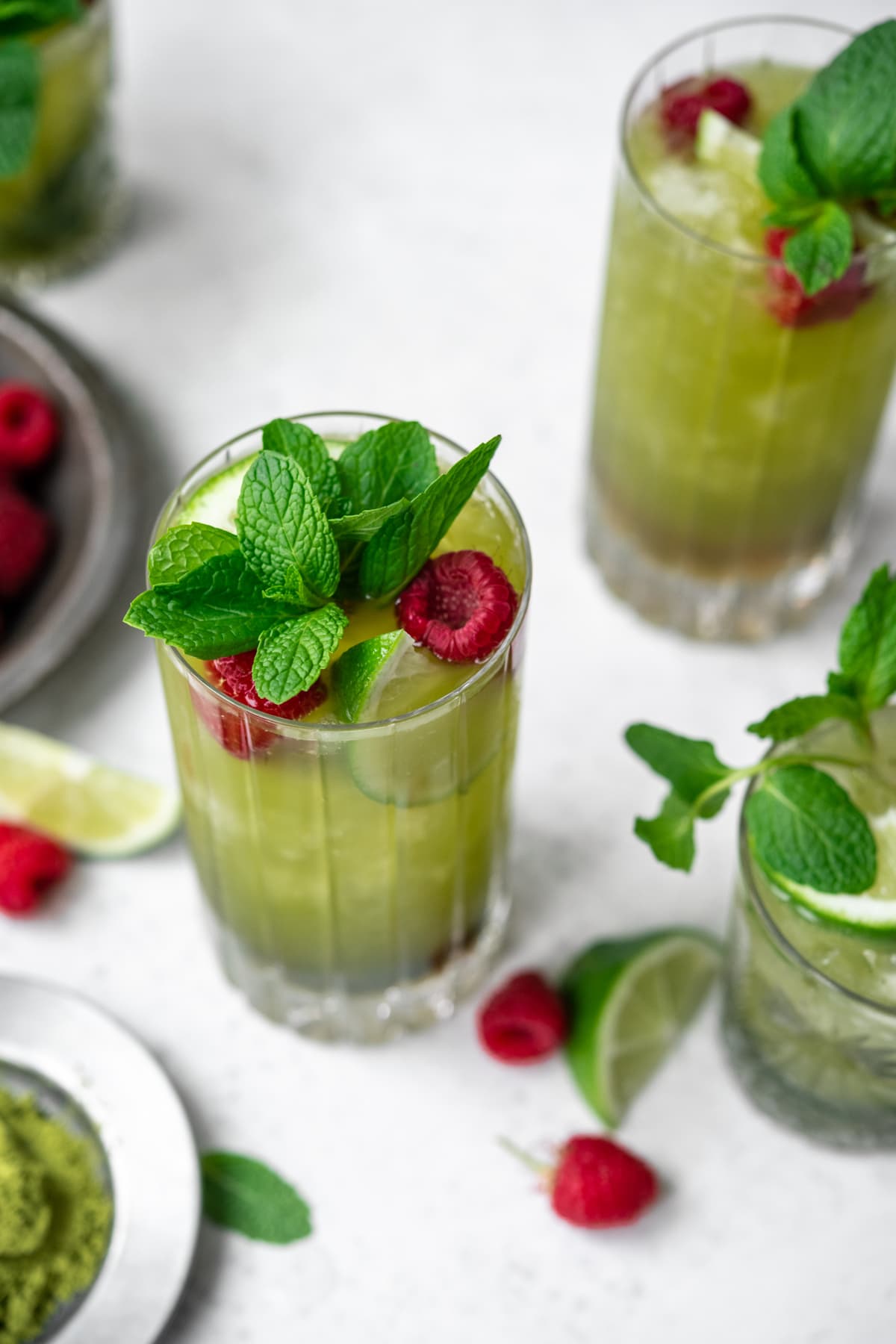 close up side view of matcha mojito with bunch of fresh mint 