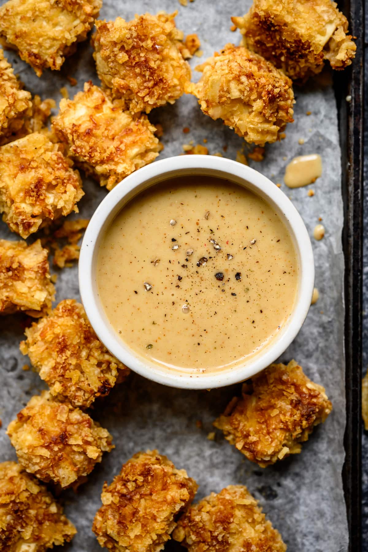 close up overhead of vegan honey mustard dressing with tofu nuggets