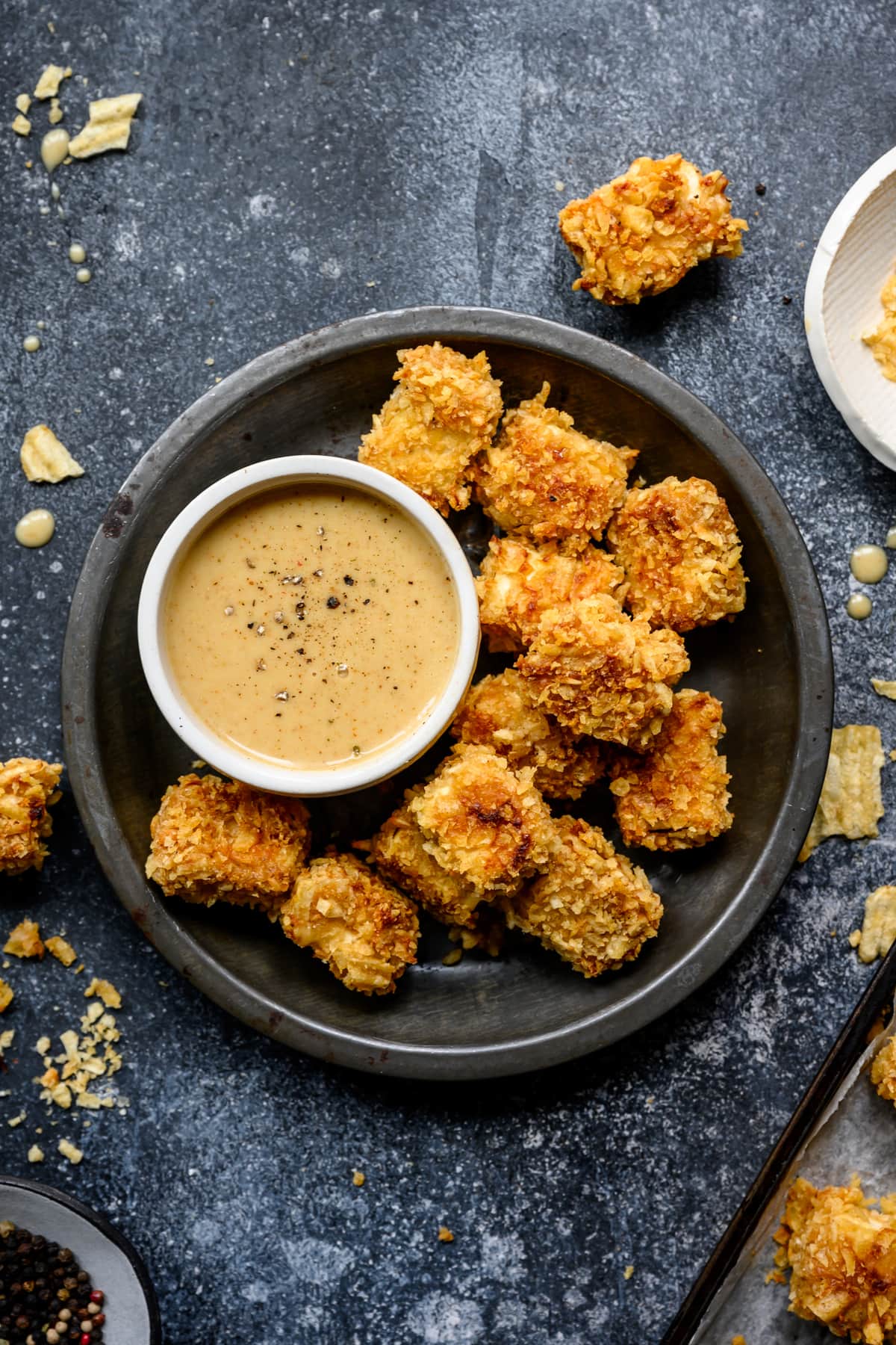 overhead view of baked tofu nuggets on plate with honey mustard sauce