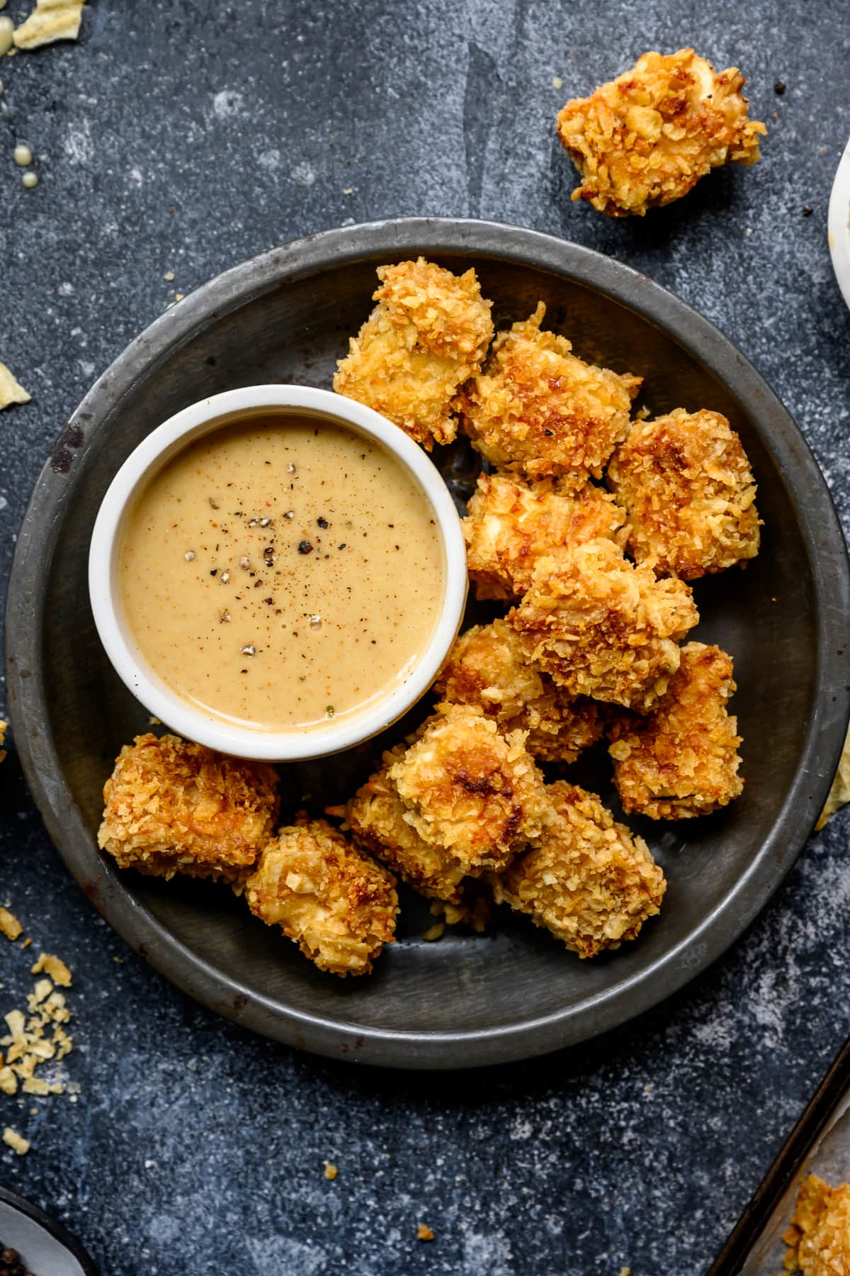 overhead view of baked tofu nuggets on plate with honey mustard sauce