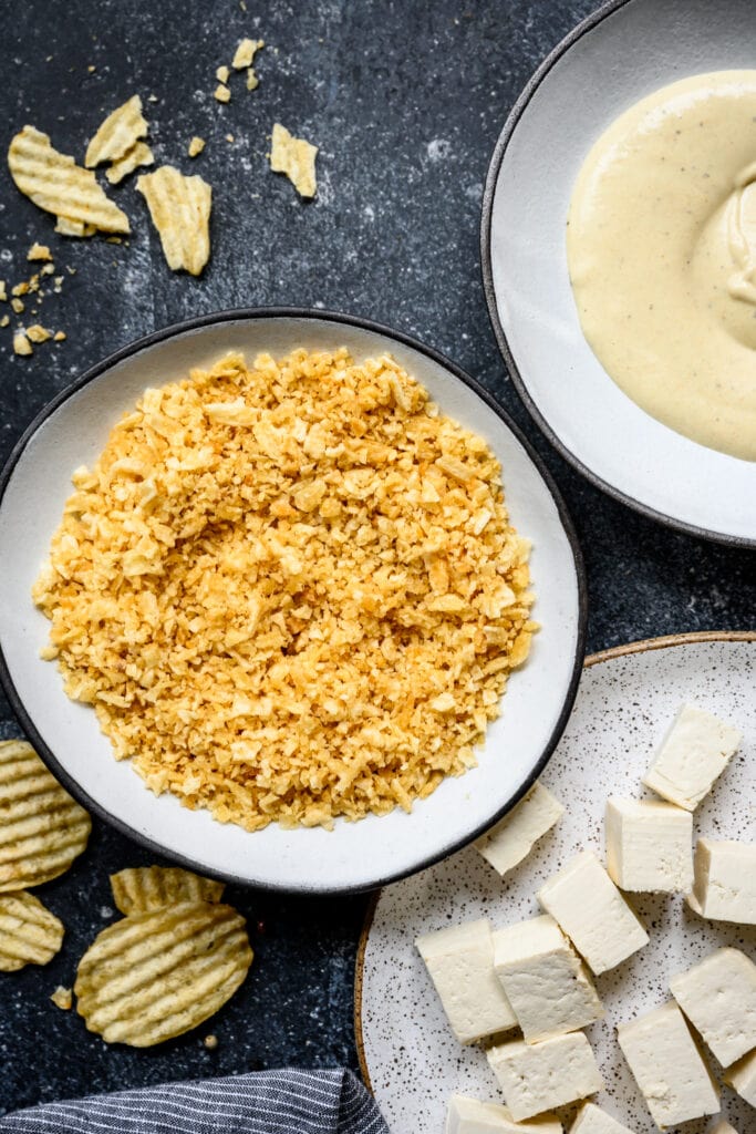 overhead view of crushed potato chips in bowl for breading tofu