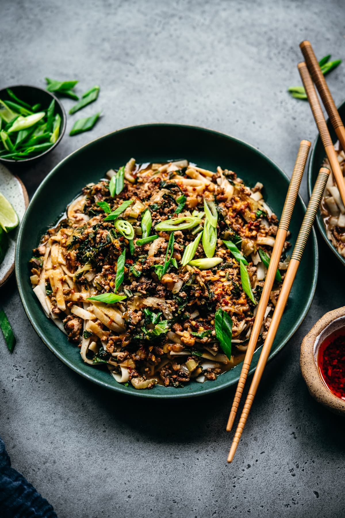 side view of vegan dan dan noodles in blue bowl