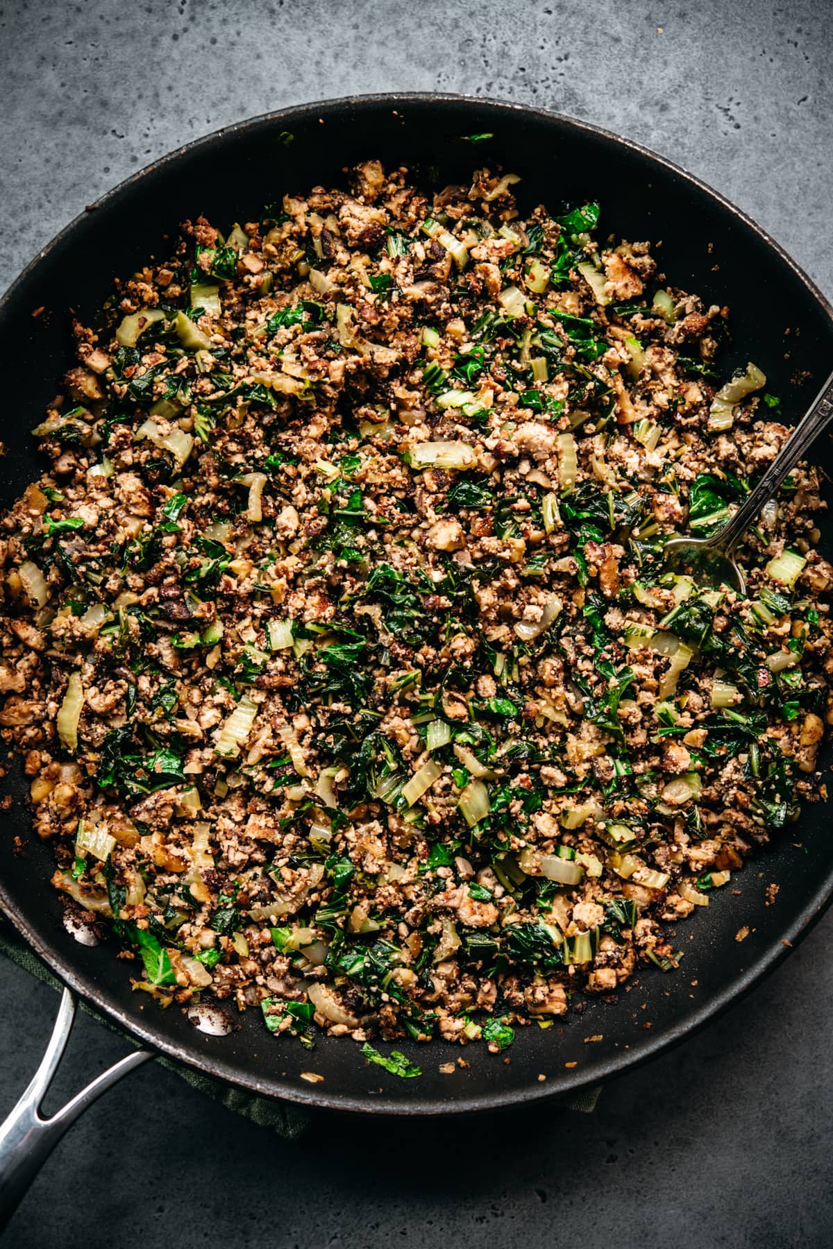 overhead view of vegan tofu, mushroom, walnut meat mixture in pan