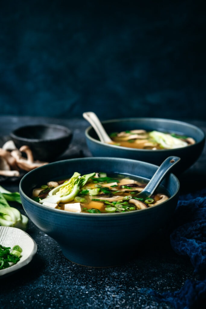 side view of vegan miso soup in blue soup bowl