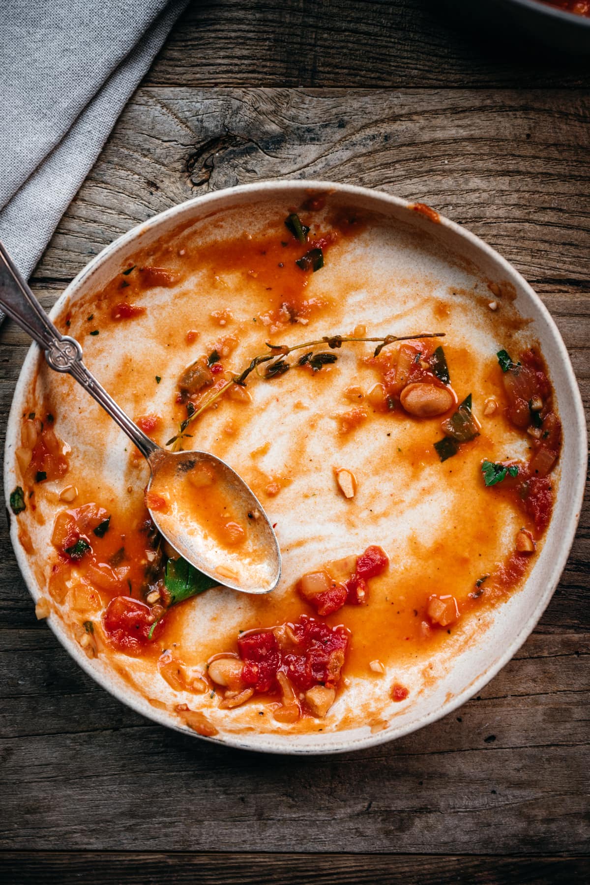 overhead view of empty bowl with remnants of tomato stew