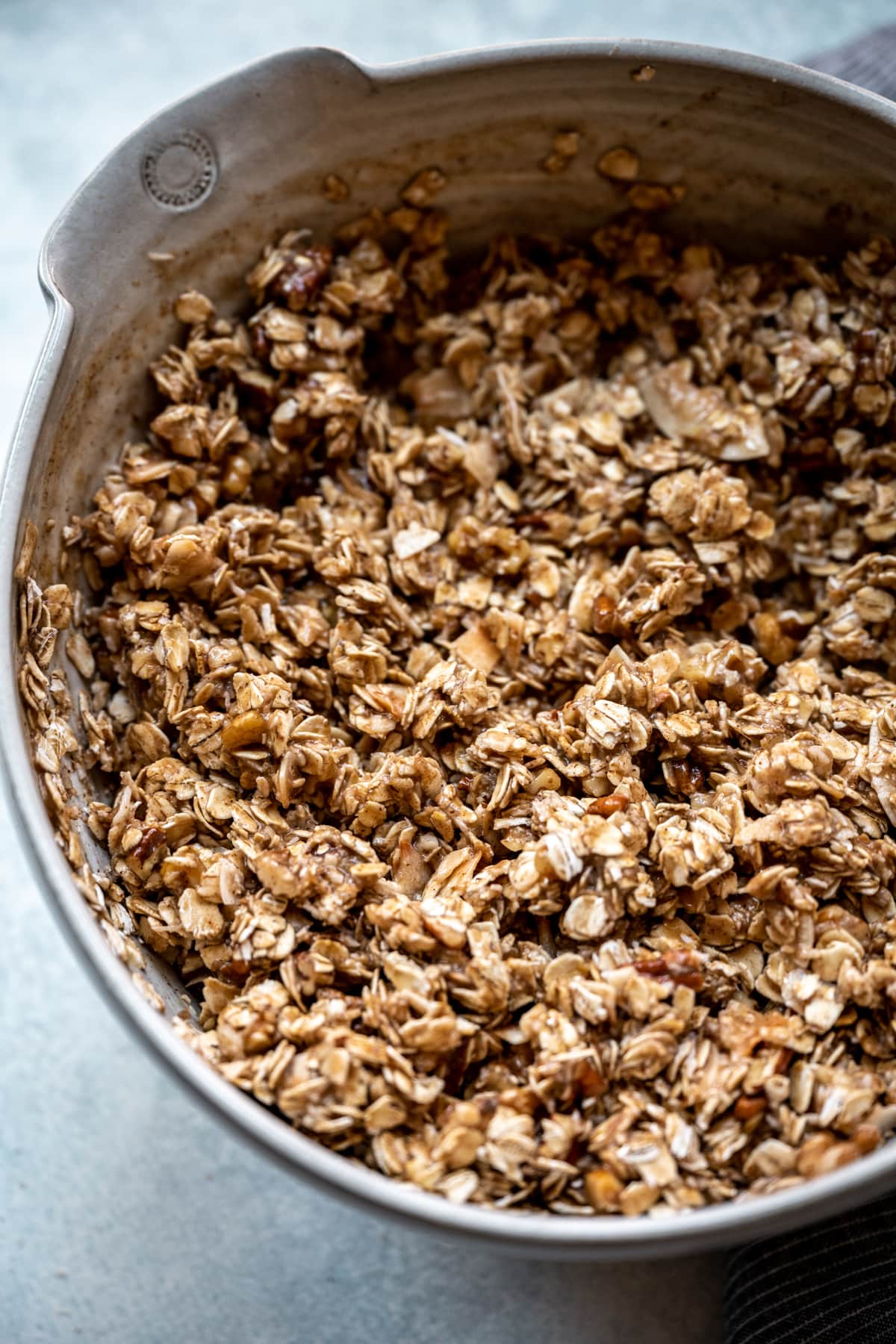 overhead view of homemade banana granola in mixing bowl before baking