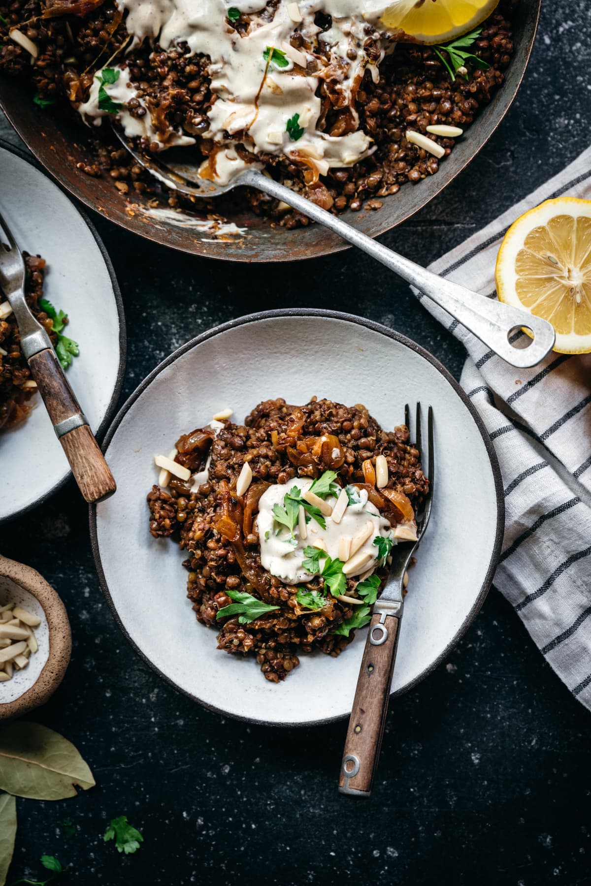 overhead view of vegan mujarada in a bowl with tahini yogurt sauce