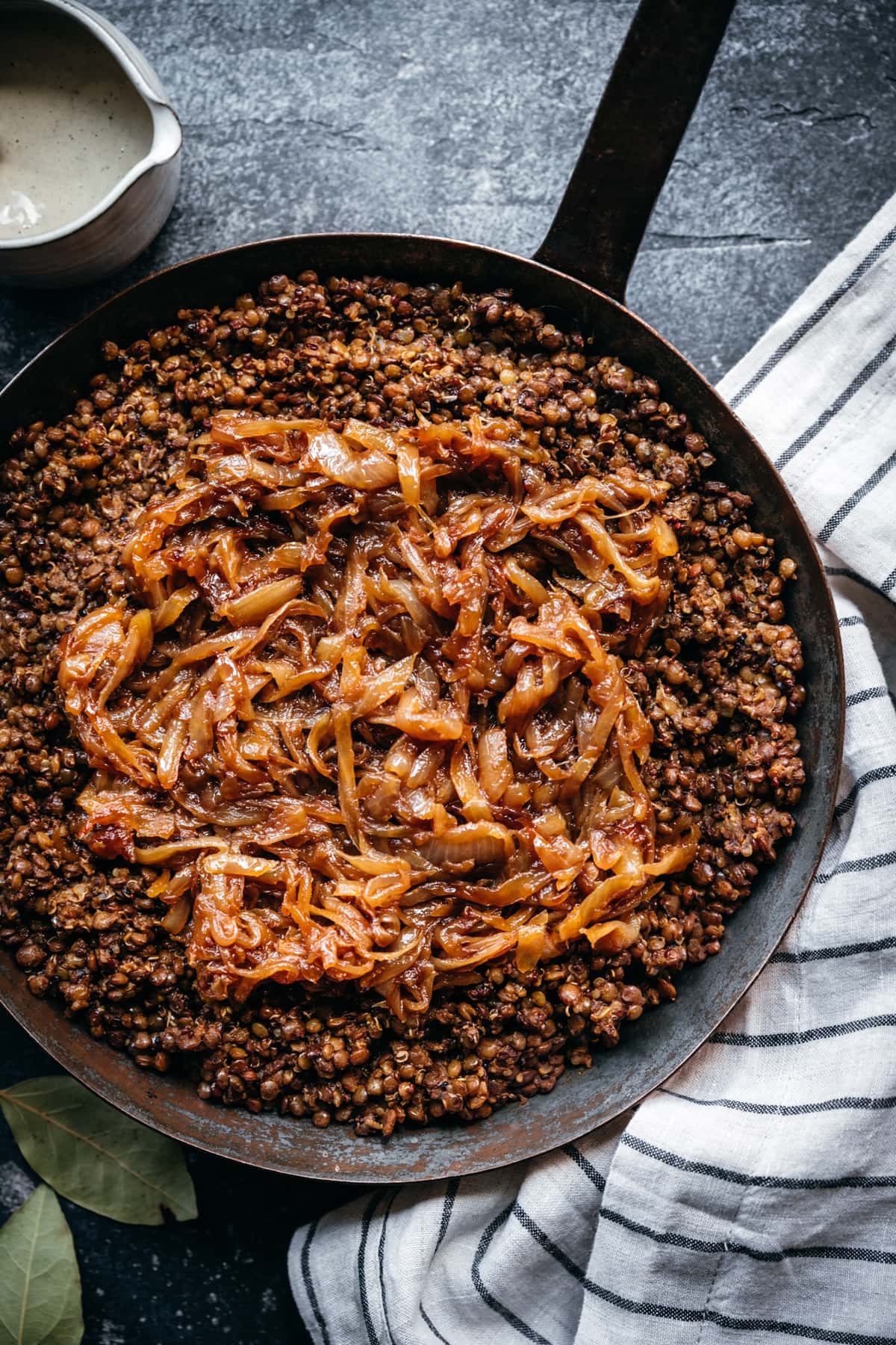 overhead view of mujadara in a pan with caramelized onions