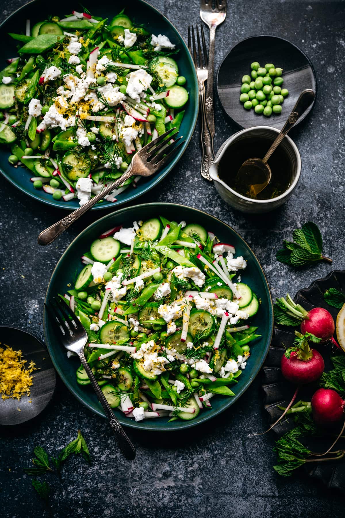 overhead view of two bowls of snow pea salad with radishes