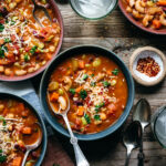 Bowl of vegan minestrone soup seen from above.