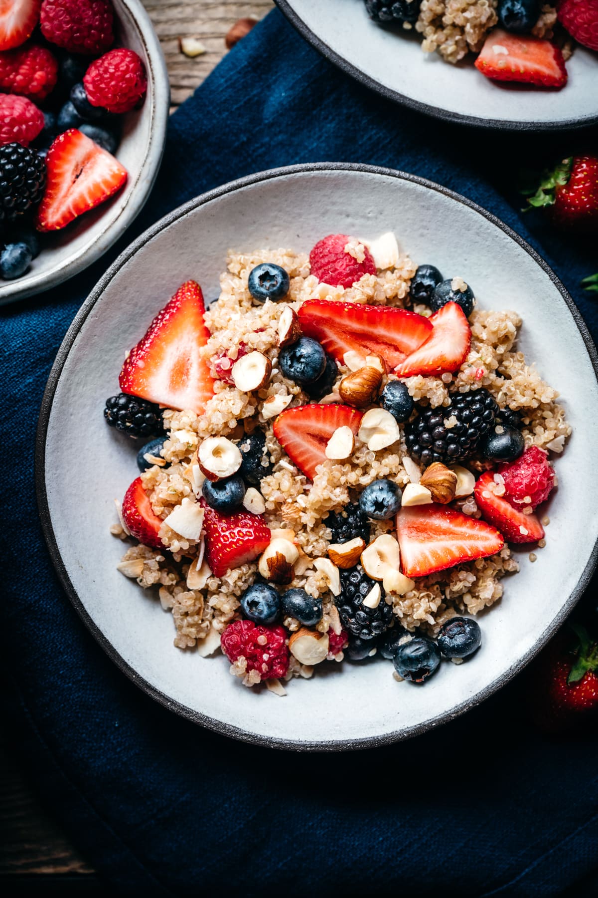 close up overhead view of vegan breakfast quinoa in bowl with berries