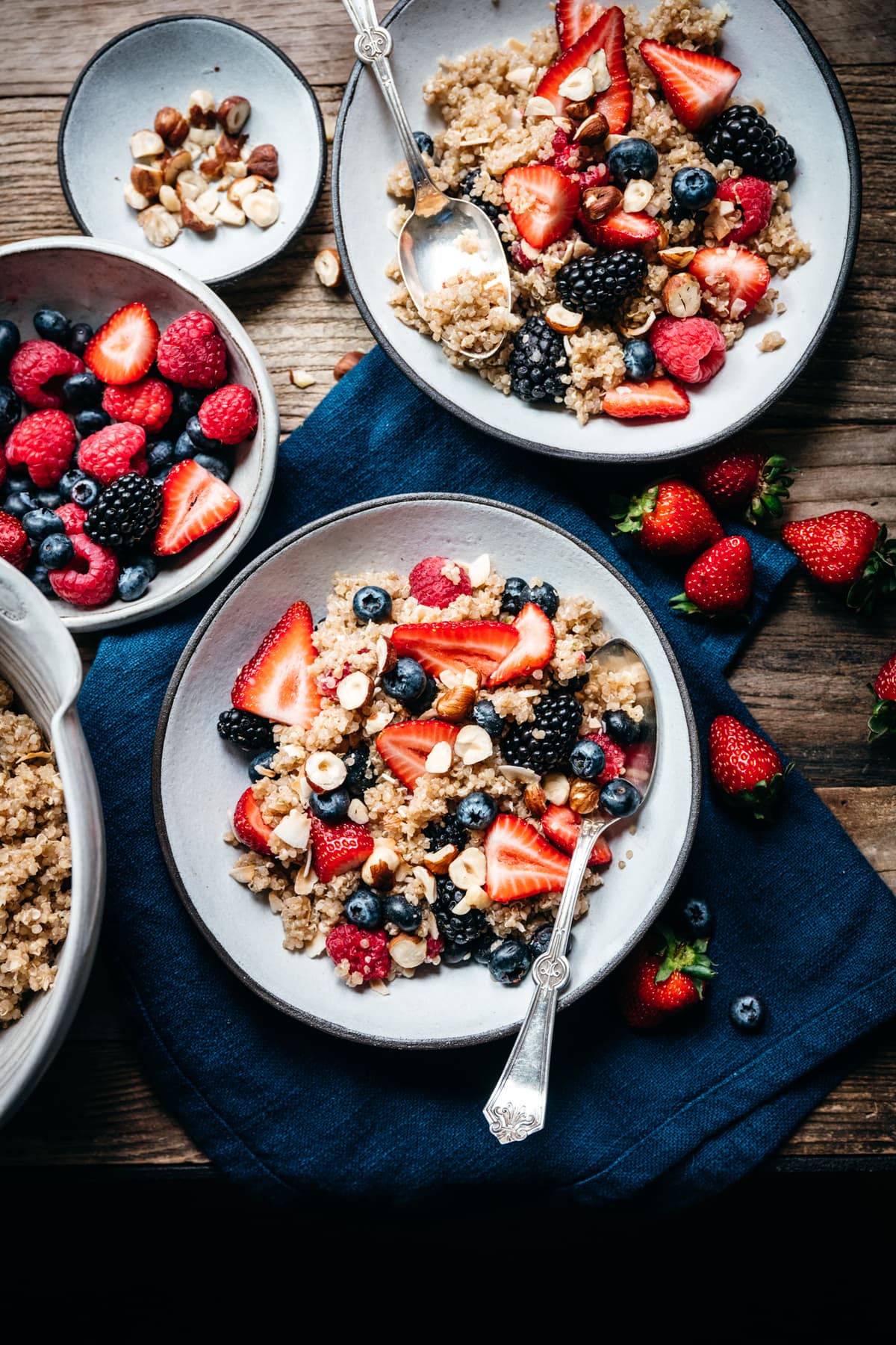 vegan breakfast quinoa with berries and coconut on wood table