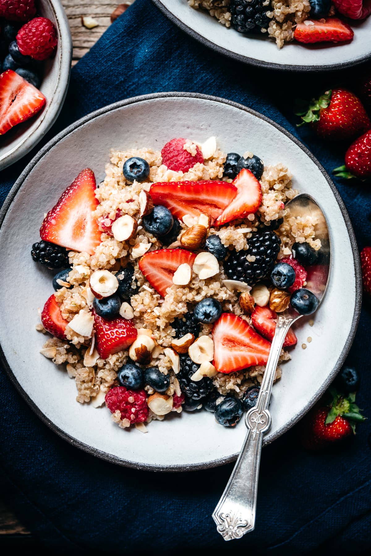 close up overhead view of vegan breakfast quinoa in bowl with berries