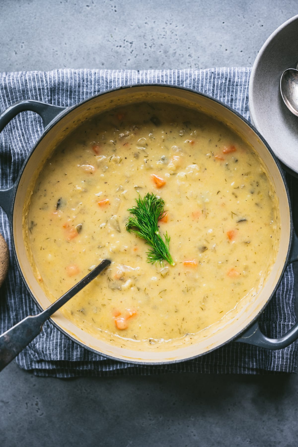 close up overhead view of vegan dill pickle soup in large pot