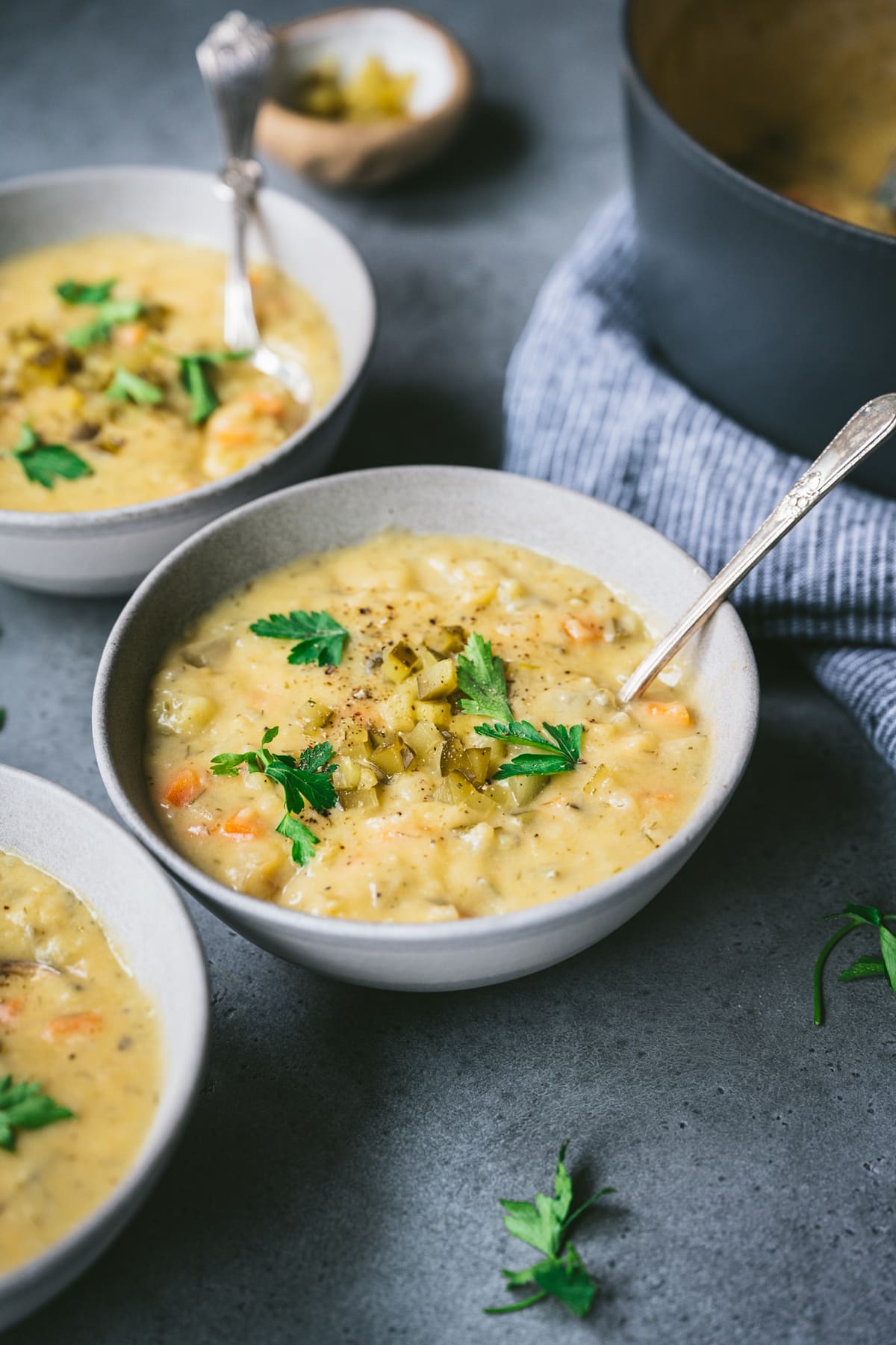 side view of dill pickle soup in bowls