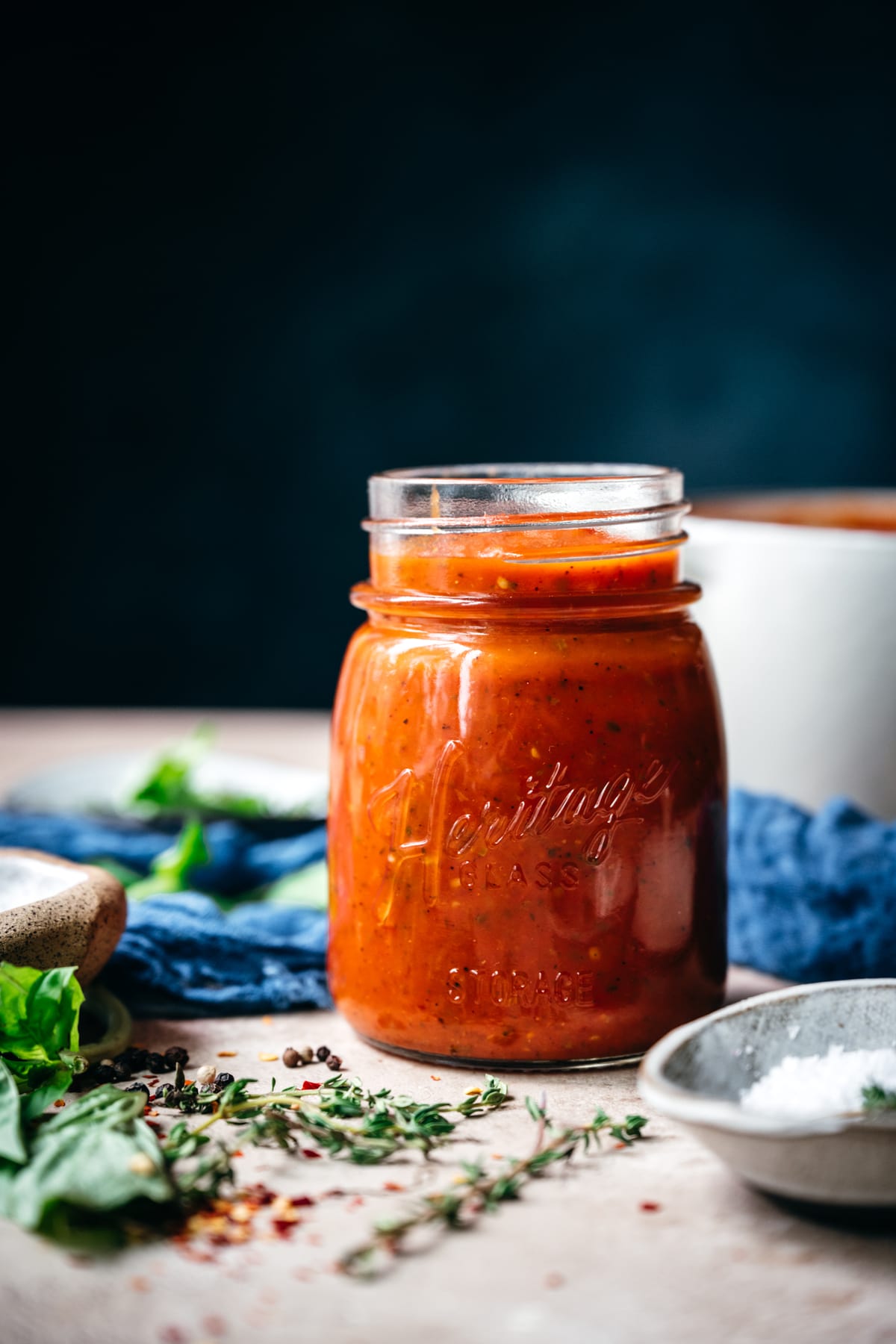 close up side view of homemade tomato sauce in a glass jar