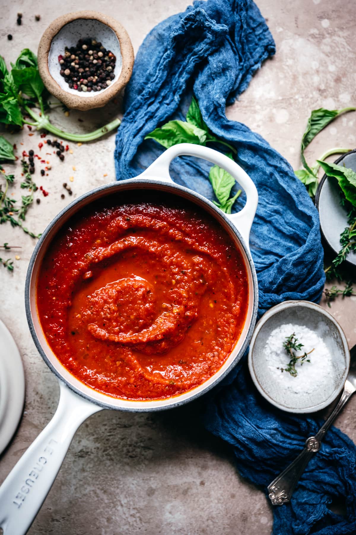 overhead view of tomato sauce in a white saucepan