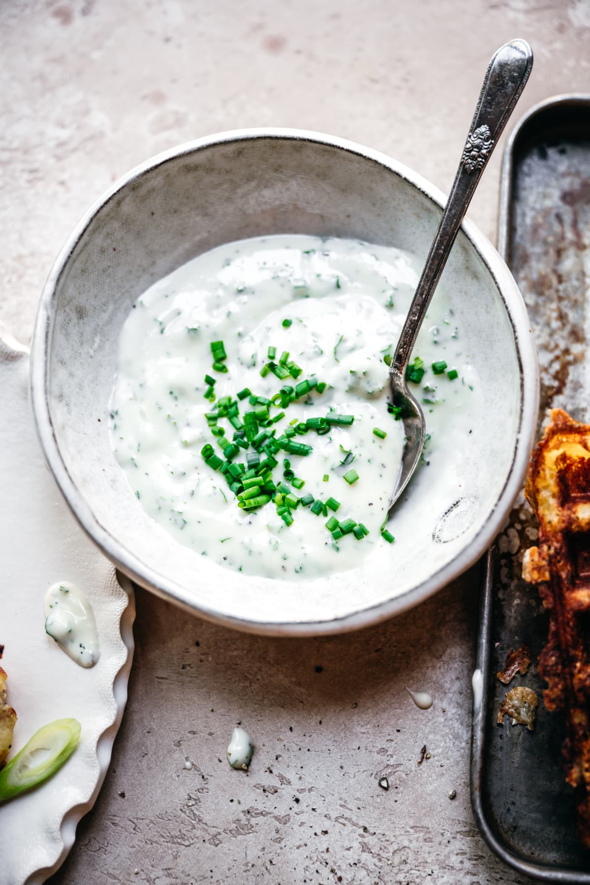 herb yogurt sauce in a small white bowl