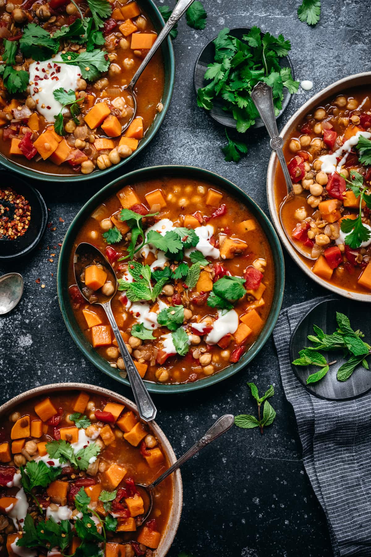 overhead view of vegan Moroccan chickpea lentil stew in bowls
